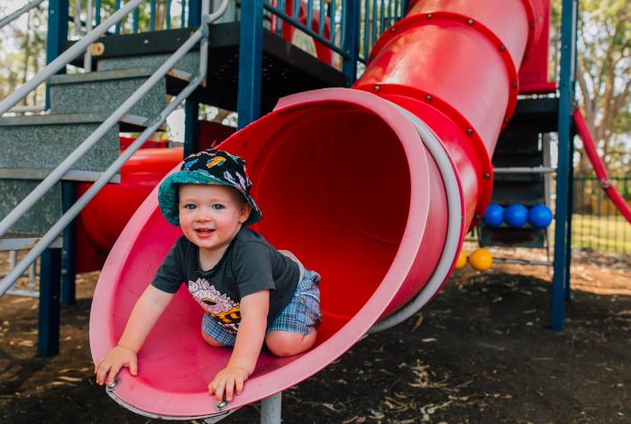 Child on slippery dip in a playground