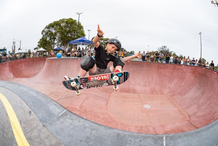 Skate trick in skatepark bowl