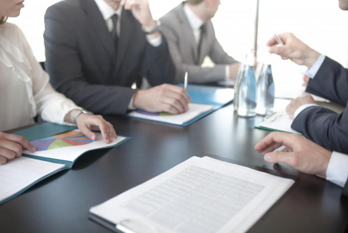 Photo of five buisness people in a meeting