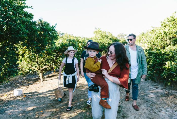 Family walking together through a farm