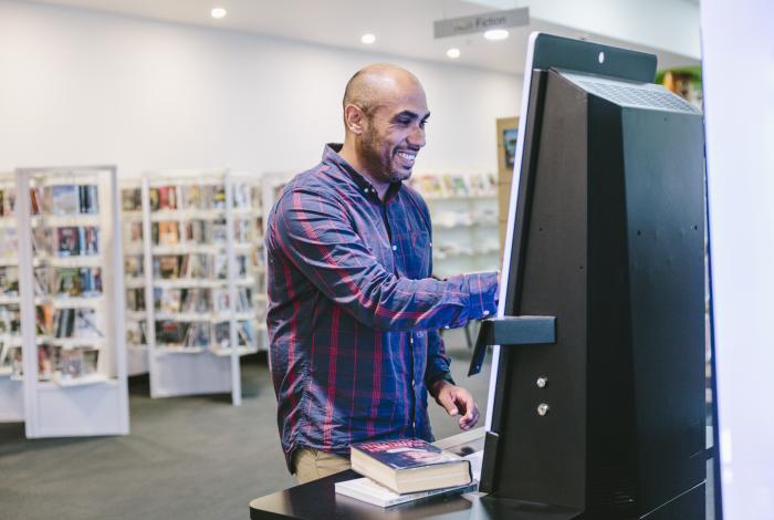 Man borrowing books from the library