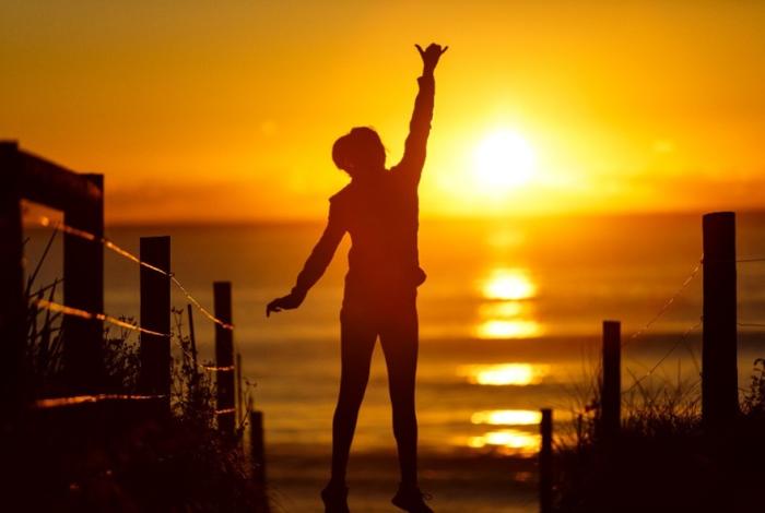 Photo of person reaching up at Wamberal Beach