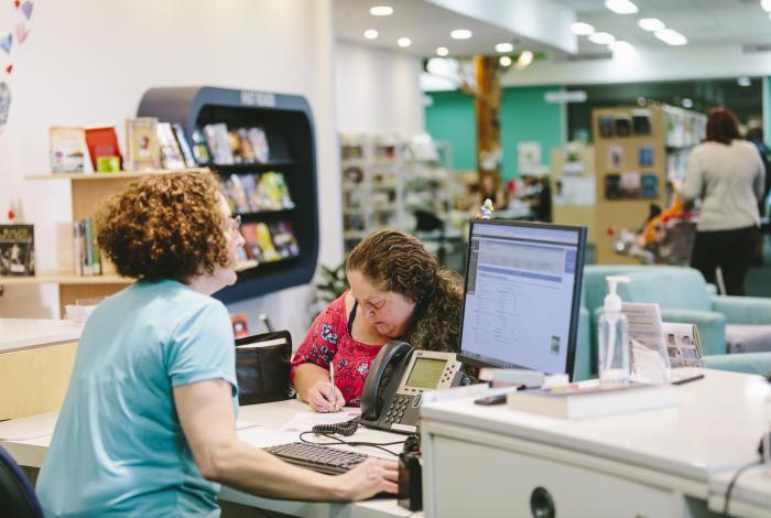 Photo of a Council staff member serving a community member